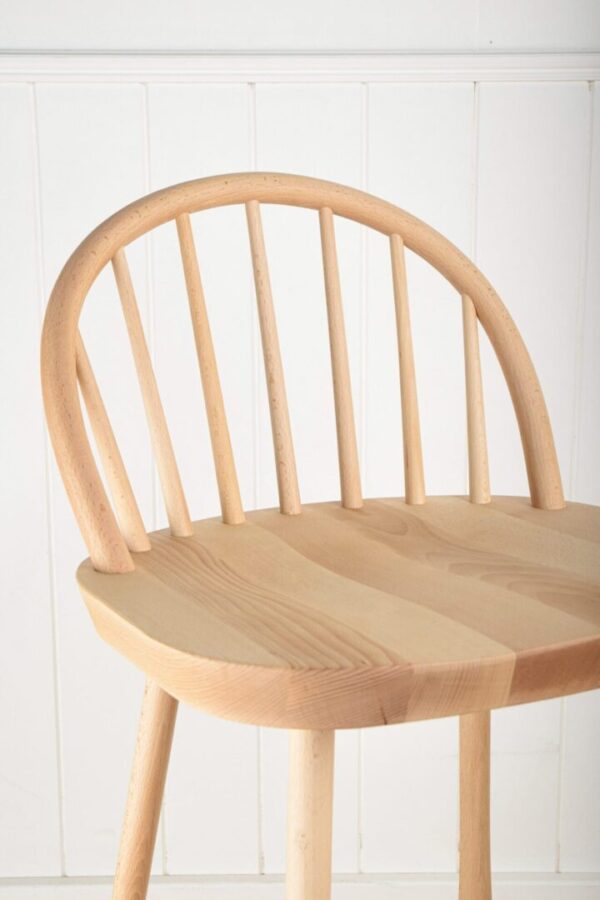 A wooden chair with a bent back and arms.