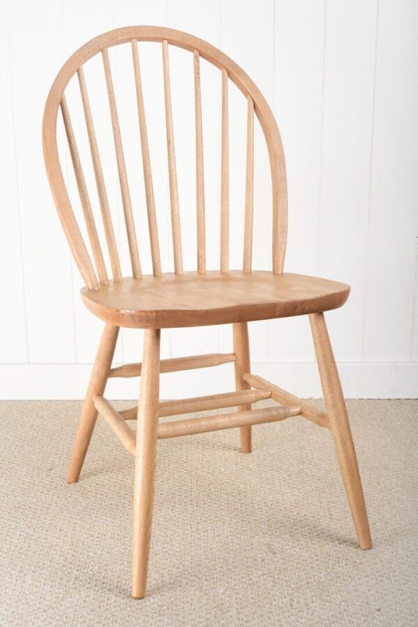 A wooden chair with a round seat and curved back.