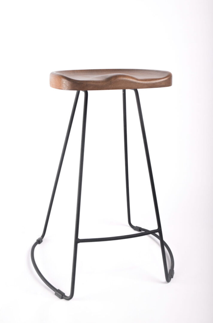 A stool with metal legs and wooden seat.