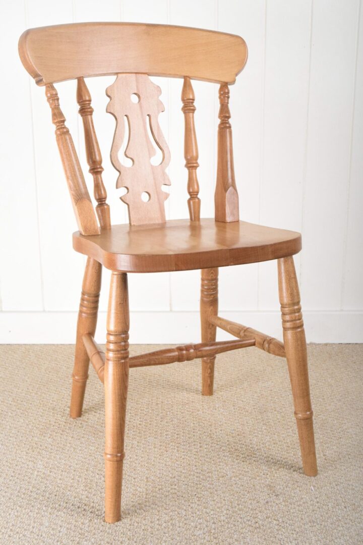 A wooden chair with a carved back and seat.