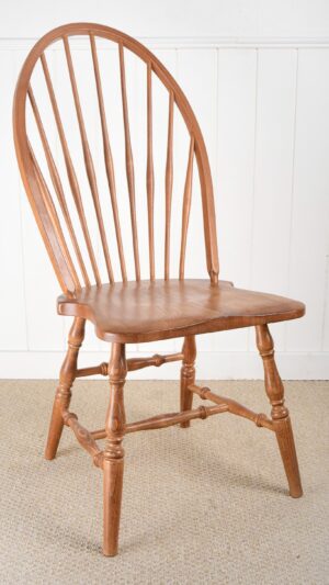 A wooden chair with a bent back and a turned leg.
