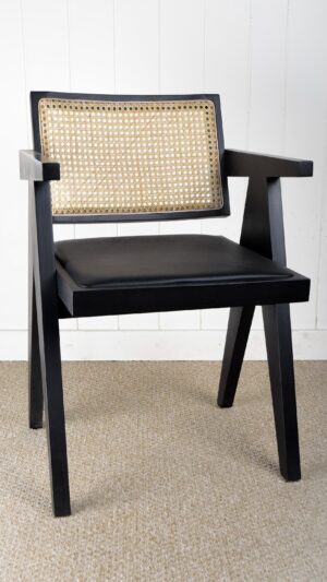 A black chair with a cane back and seat.
