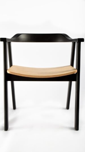 A black chair with wooden seat and back.
