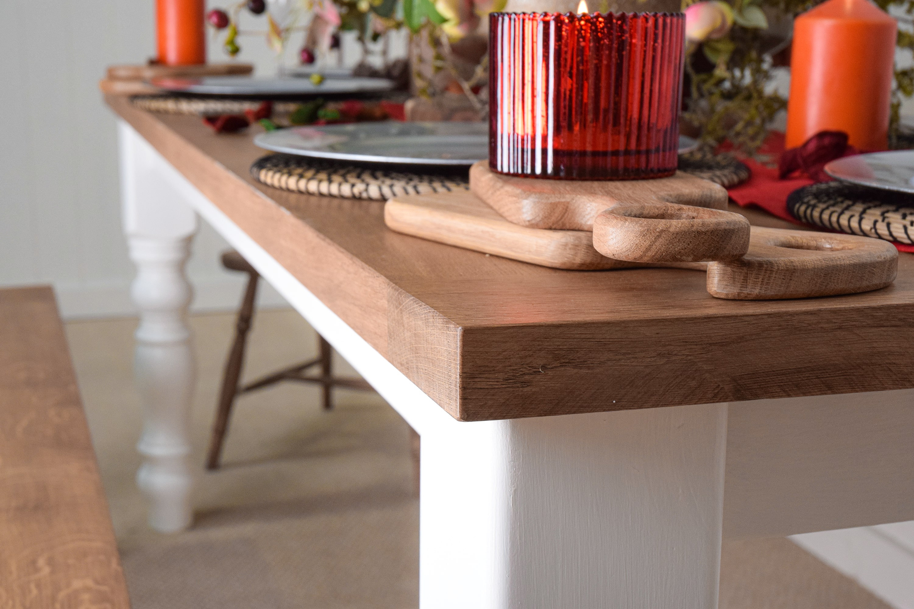 A table with wooden plates and a candle on it.