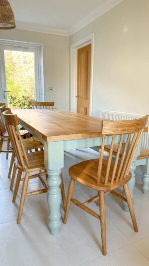 A dining room table with six chairs and a bench.