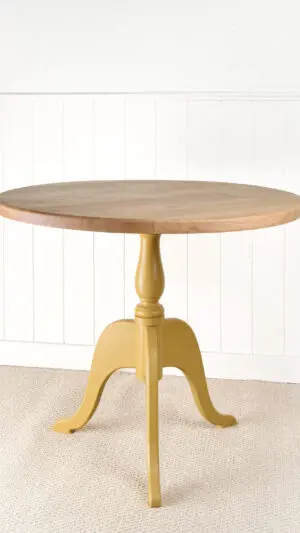 A table with a yellow base and wooden top.